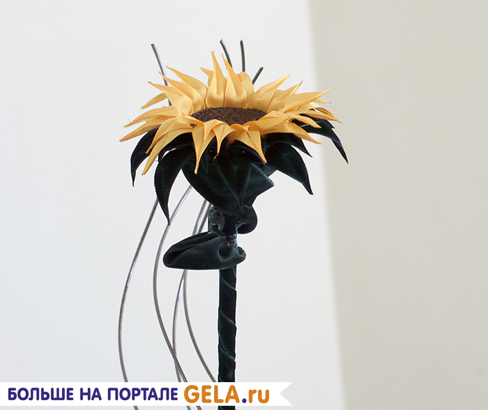 6. Если цветку нужно сделать стебель, то лучше использовать деревянную круглую планку. Планку обмотайте тонкой бархатной лентой и нашейте несколько листьев для большей реалистичности.